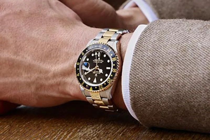 Rolex Certified Pre-Owned Watch on wrist featuring a black dial and bezel