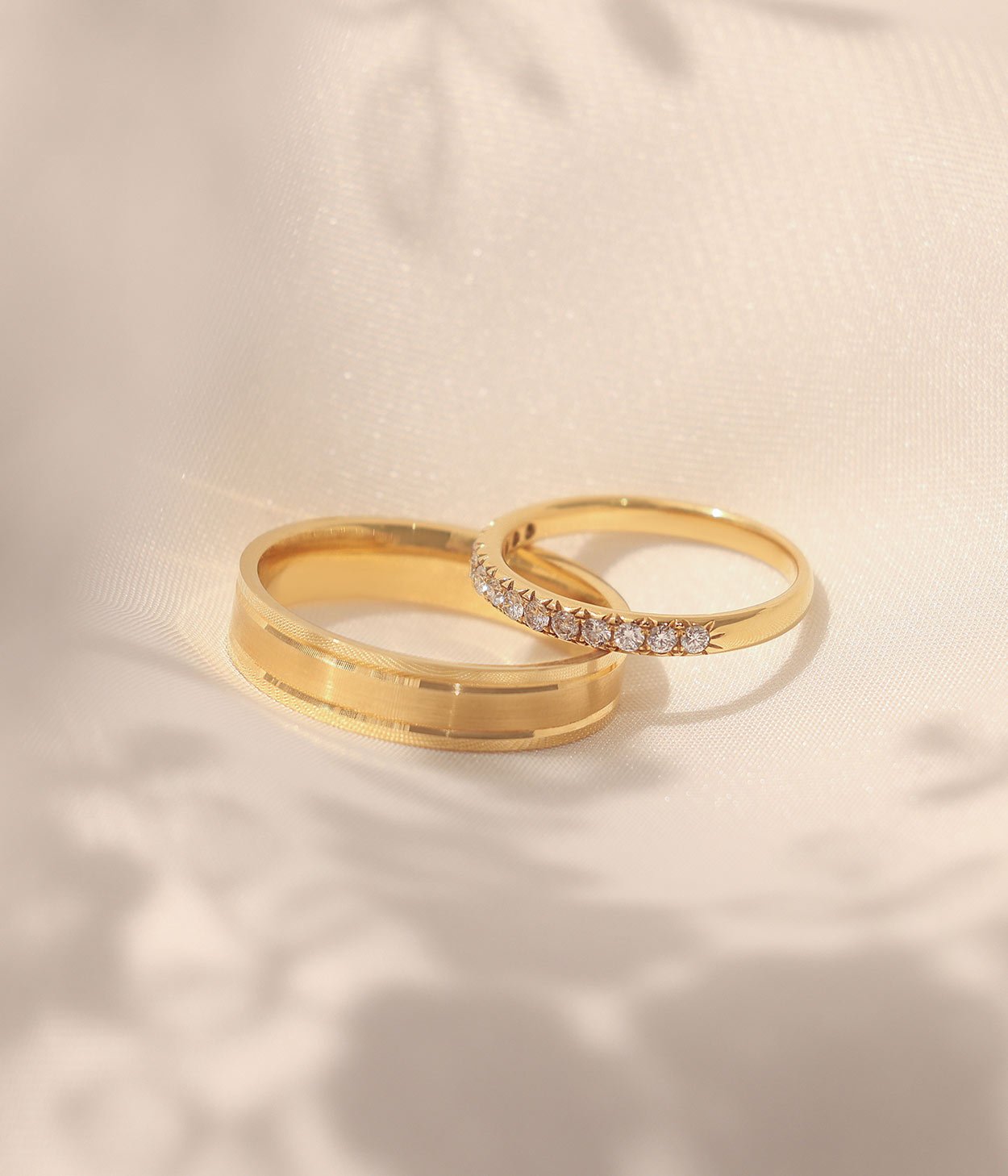 A diamond set wedding band and a three stone engagement ring, both in platinum