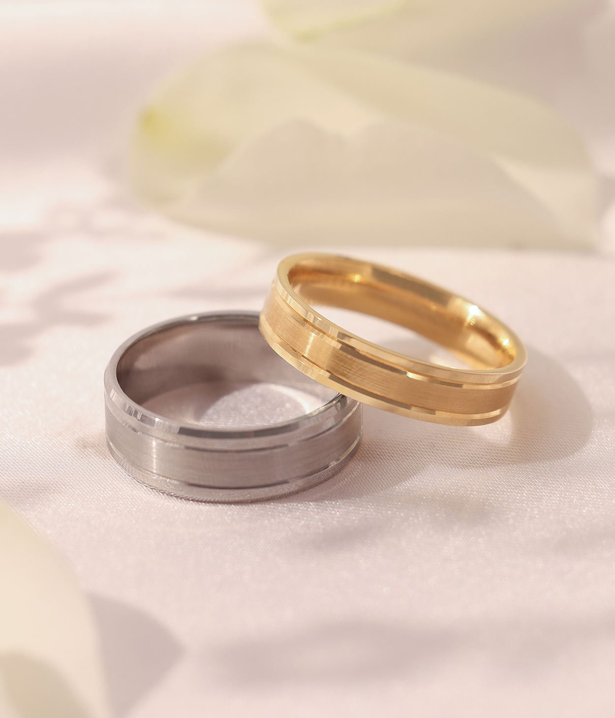 Two plain wedding bands, one in palladium and another in 18ct yellow gold, with both polished and matte finishing