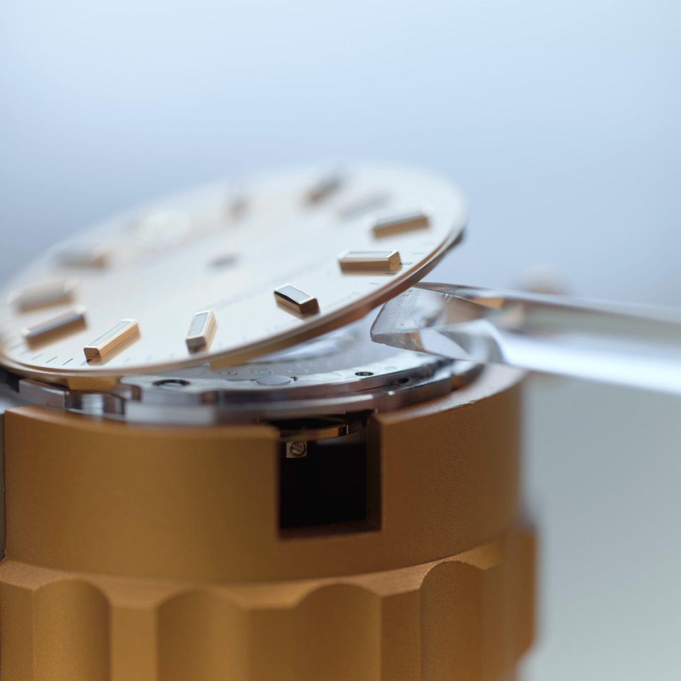 The removal of a dial from its case, as part of the servicing procedure