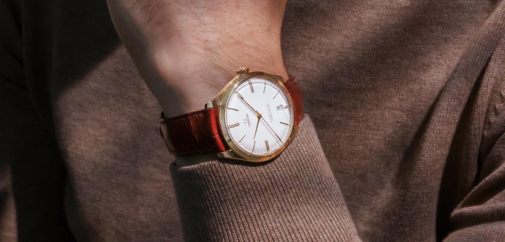 Pre-Owned OMEGA with a brown strap on wrist