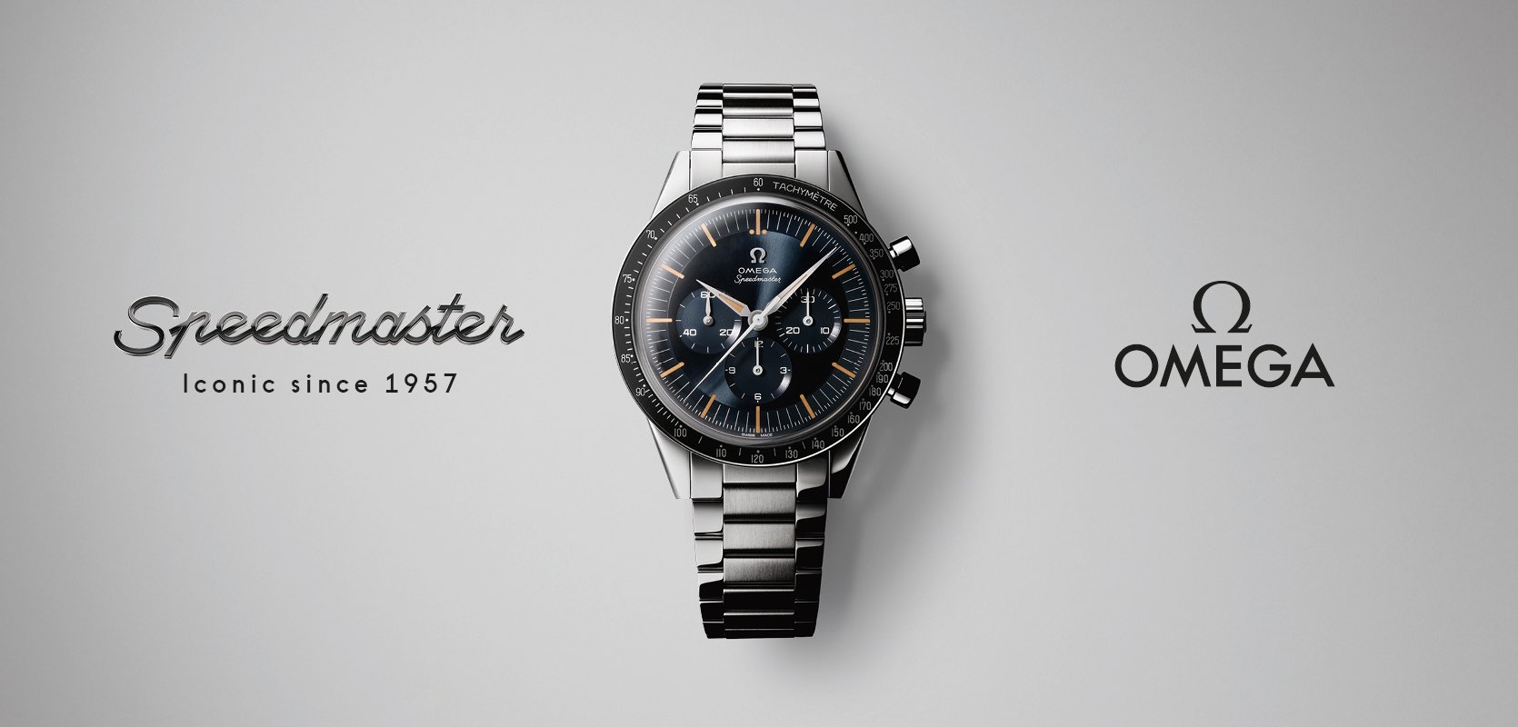 An OMEGA Master Co-Axial 8750 movement, beside a larger drawing and an OMEGA branded loupe.