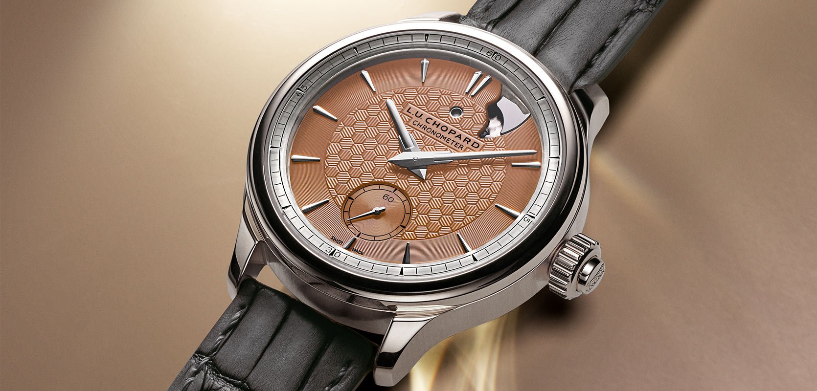 A new Chopard watch with a salmon dial, 18ct white gold case and leather strap.