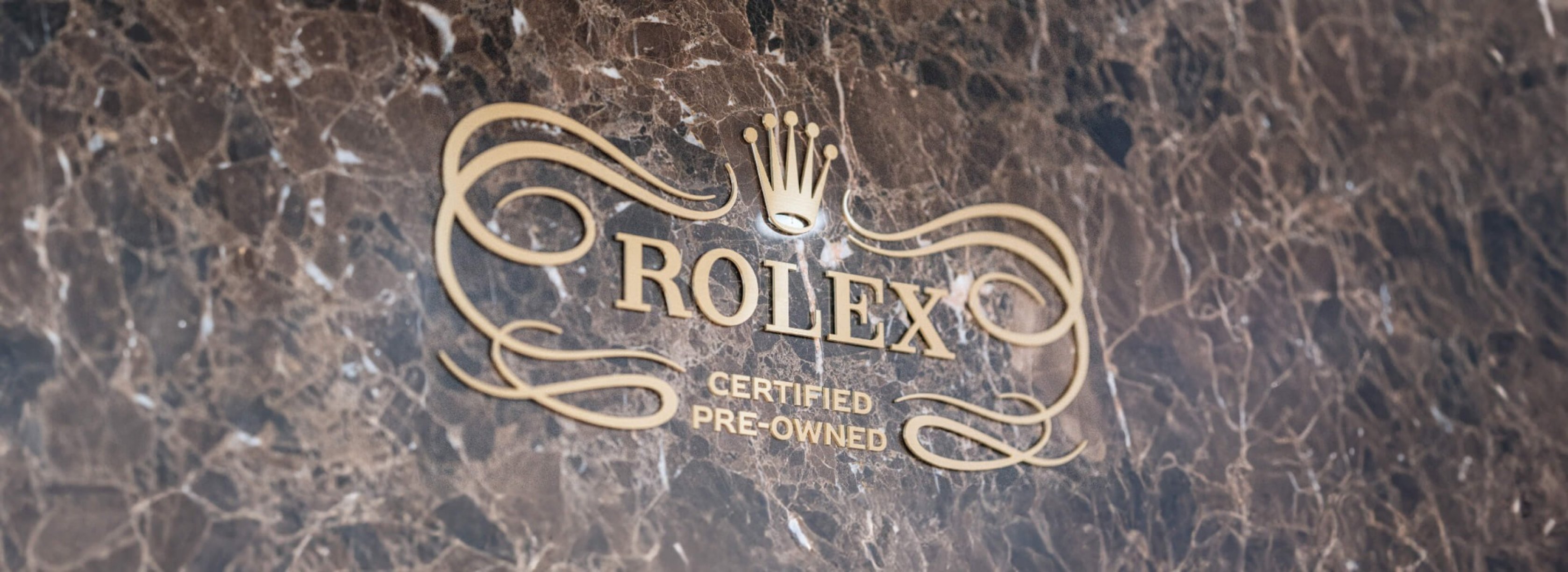 Rolex Certified Pre-Owned Logo in Gold on Marble