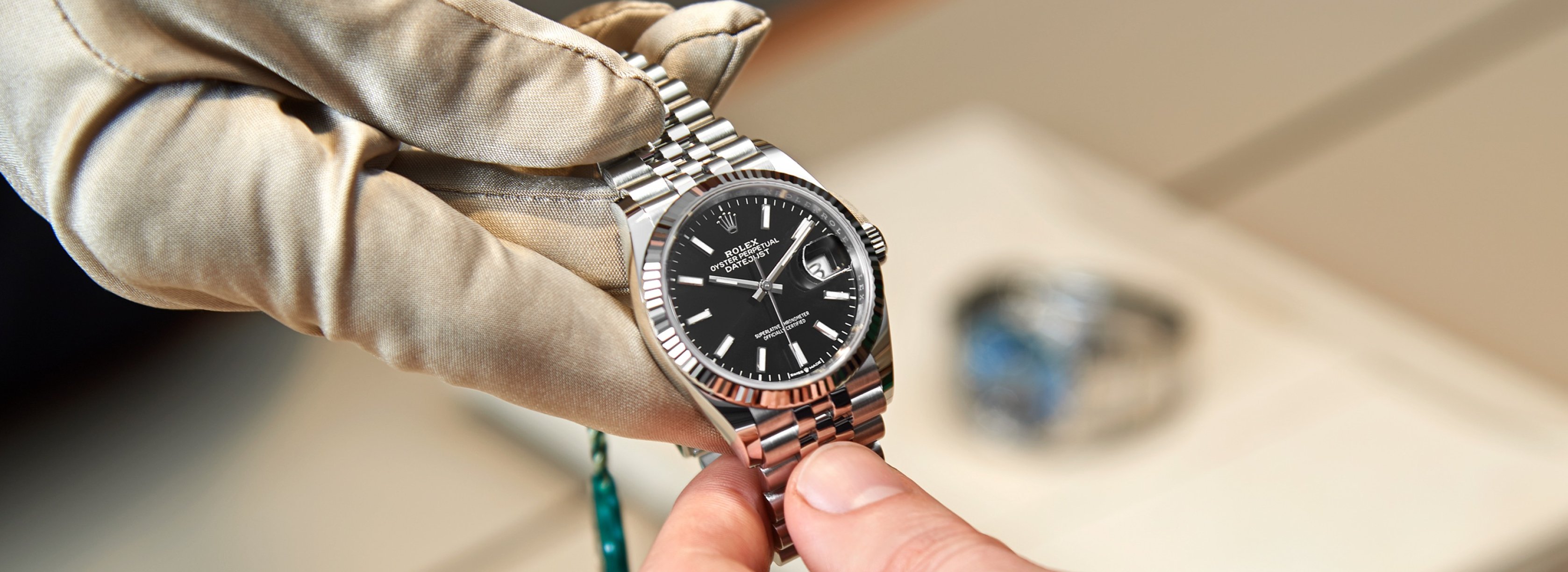A Rolex Datejust watch with a black dial, fluted bezel and Jubilee bracelet