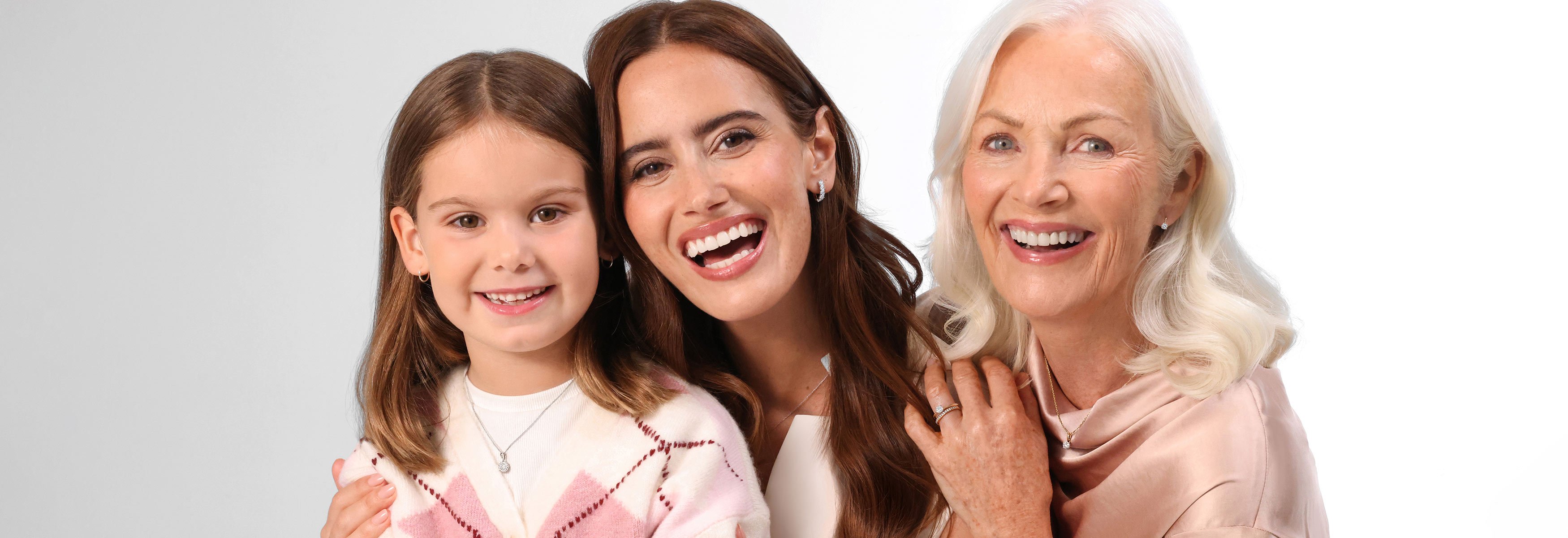 Three generations of ladies including a young girl, woman in her mid-30s and an older woman who is the grandma.