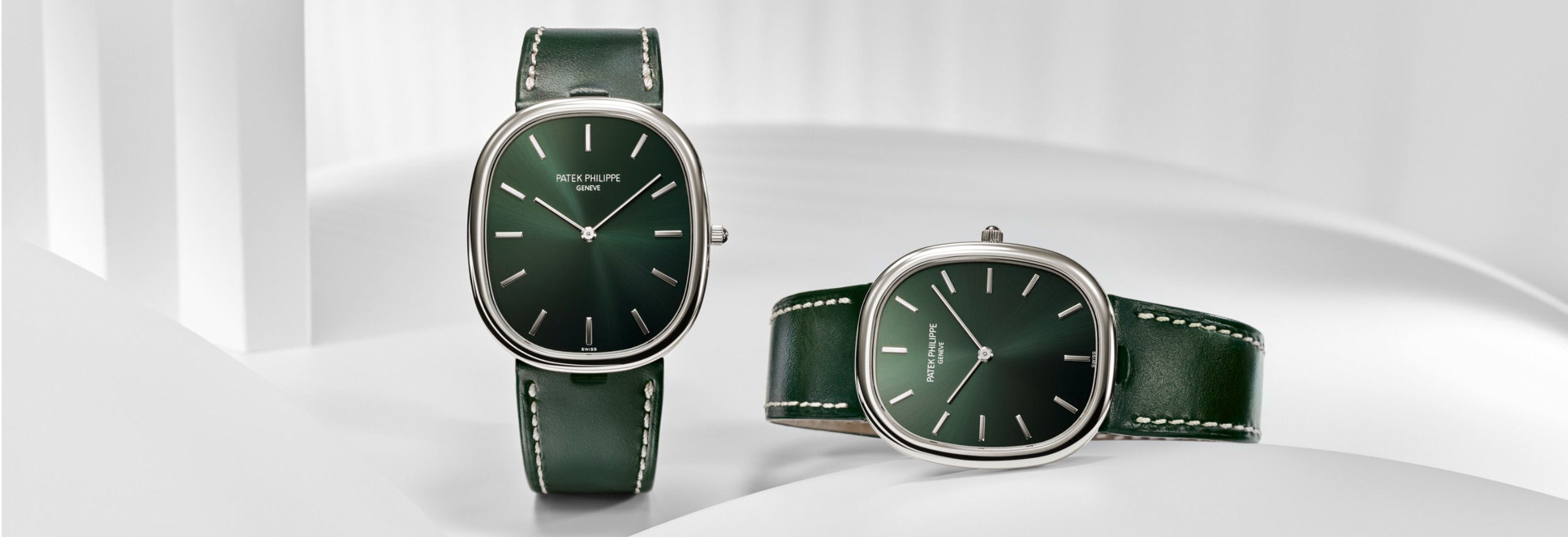 Two Patek Philippe watches from the Golden Ellipse collection, with a green dial and green leather strap.