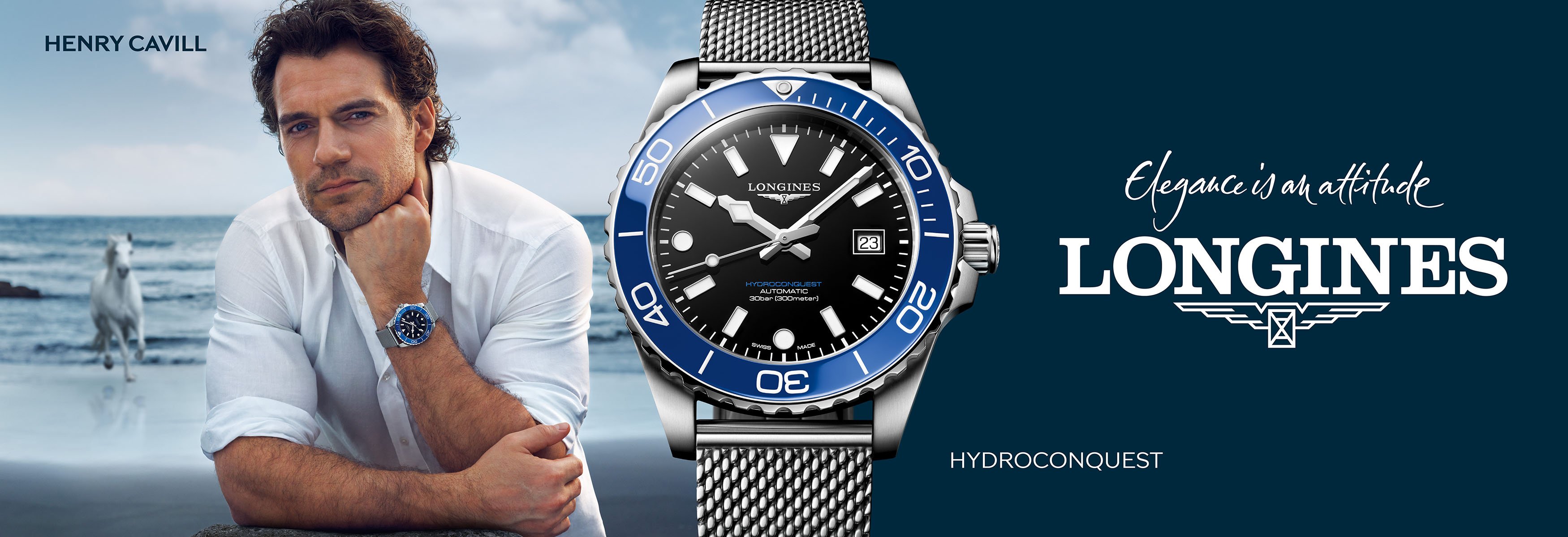 A person wearing a Longines HydroConquest watch while standing on a rocky shoreline, with a separate product image of the blue‑and‑silver Longines HydroConquest displayed on a dark blue background alongside the Longines logo.