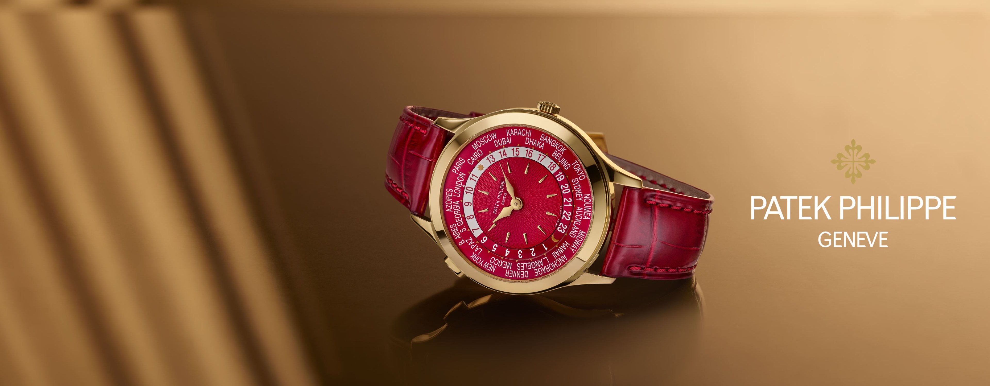 A new Patek Philippe Grand Complications watch in 18ct yellow gold, with red accents on the dial and strap.