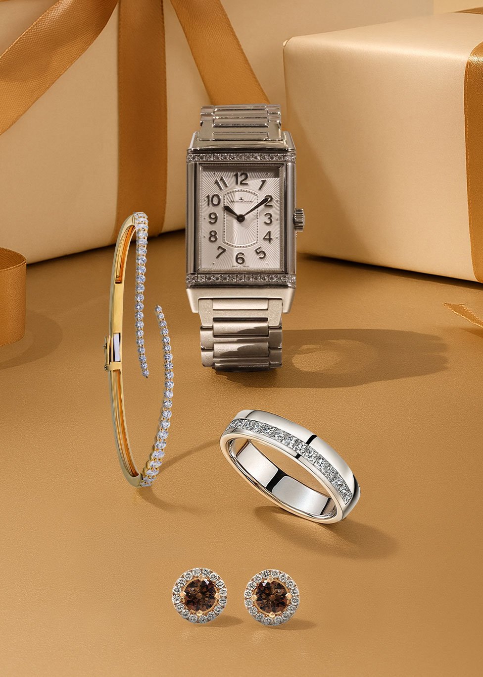 A layout with a gold backgorund featuring a ladies watch, bracelet, diamond eternity ring and stud earrings.