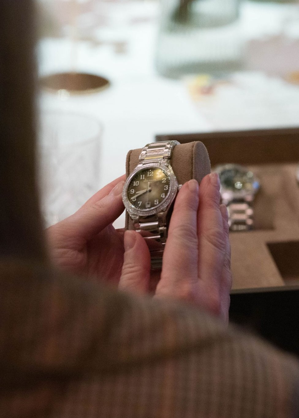 A lady admiring the Patek Philippe Twenty~4 timepiece in white gold with diamonds