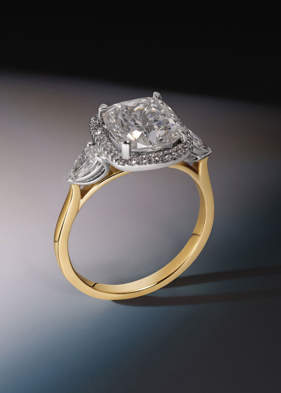 An 18ct yellow gold laboratory grown diamond engagement ring, with a cushion cut diamond centre, diamond halo and side stones all set in platinum.