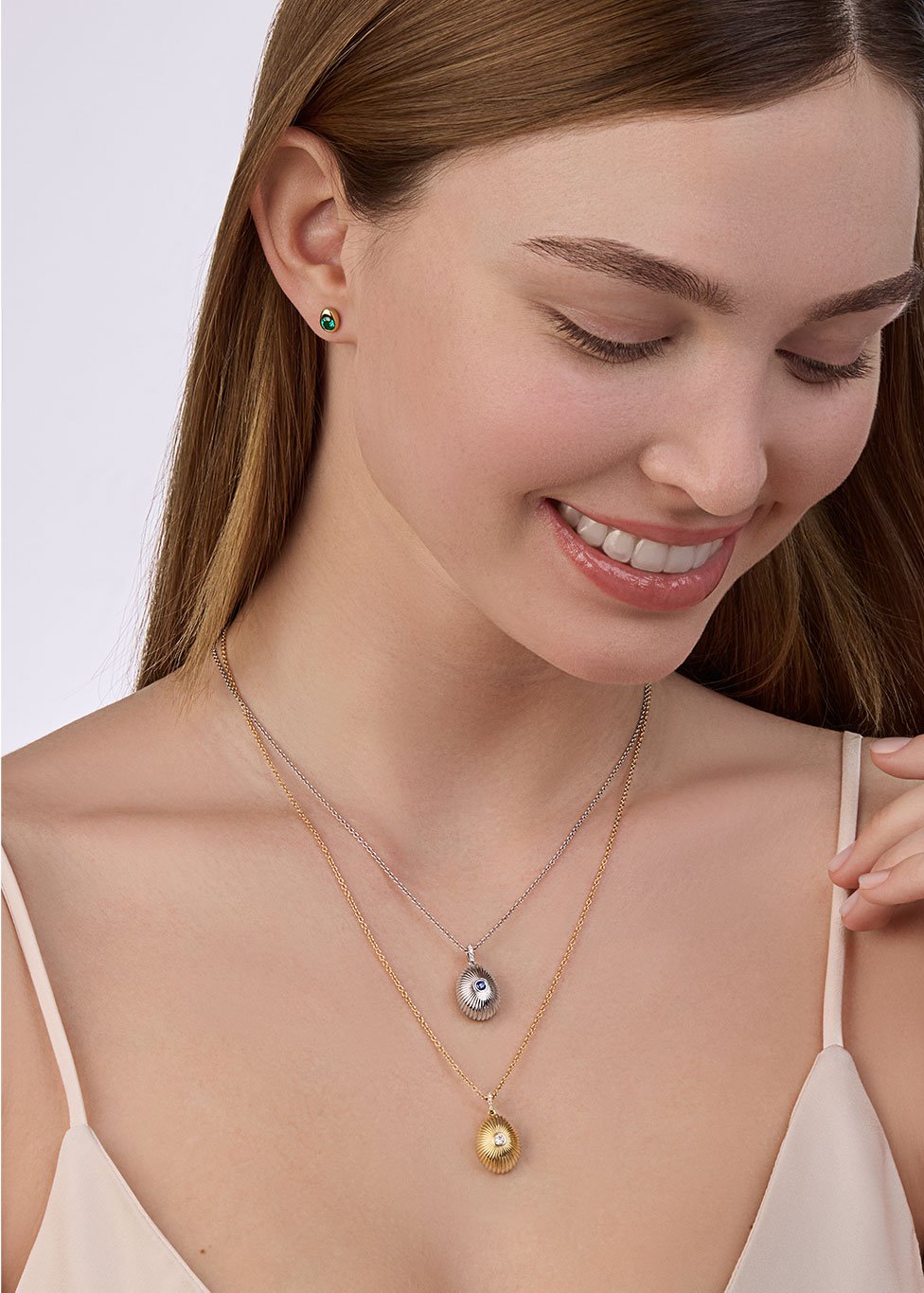 A model wears two Faberge pendants, one in 18ct white gold and the other in 18ct yellow gold.